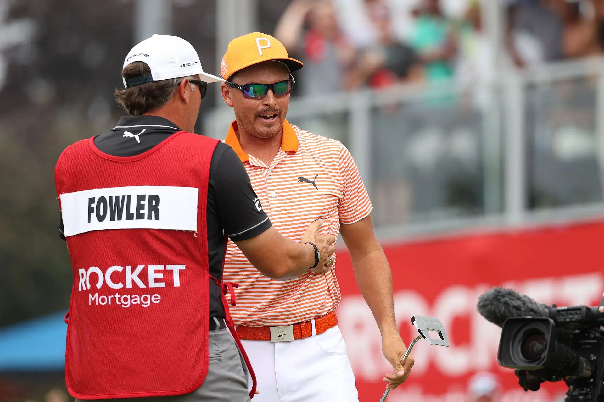 Rickie Fowler celebrates the win with his caddie at the 2023 Rocket Mortgage Classic - Source: Getty